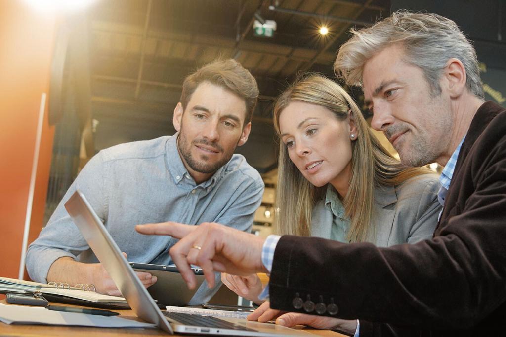 Sales team working through presentation with manager